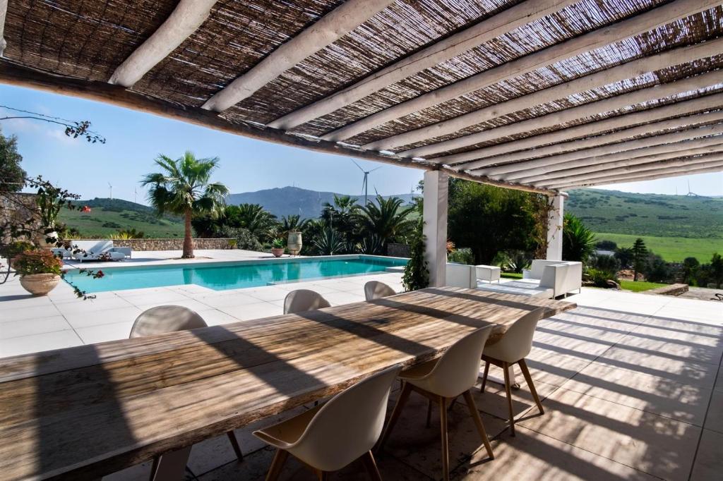 Terraza con mesa y piscina